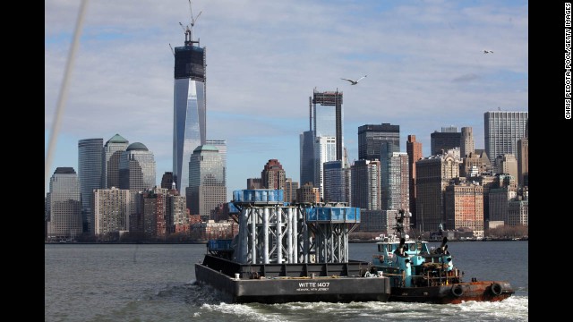 Parts of the spire for the new skyscraper make their way on a barge from Port Newark to Lower Manhattan on December 11.