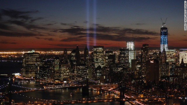 The "Tribute in Light" shines near the spots where the twin towers once stood as red, white and blue light up the new building on the 11th anniversary of the attacks. 