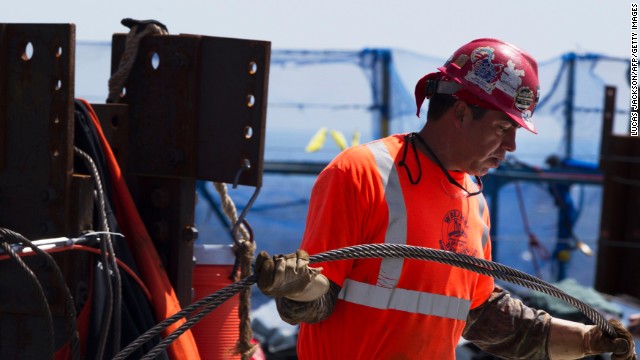 Ironworker Steven Cross carries steel cable across the top of the building on April 30, 2012.