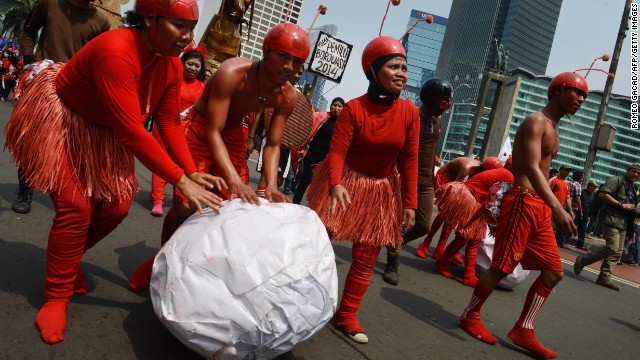 Indonesian workers wearing ant costumes to depict the exploitation of workers participate in a march to the presidential palace in Jakarta.