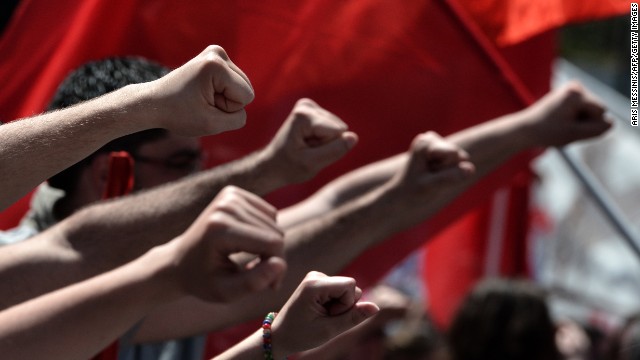 Participants raise their fists during a demonstration in Athens.