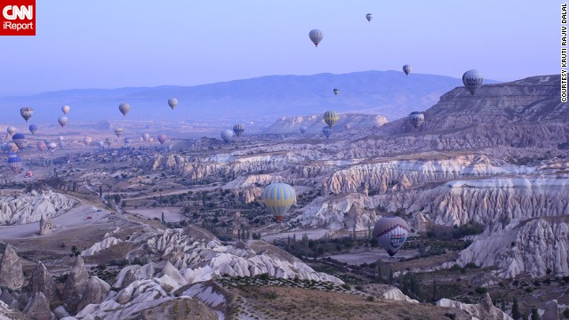 Hot air balloons float over the otherworldly <a href='http://ireport.cnn.com/docs/DOC-912180'>valleys of Cappadocia</a> at dawn.