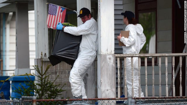 Investigators remove evidence from the house on Seymour Avenue in Cleveland where the three women were held.