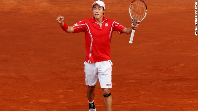 Kei Nishikori celebrates his victory over 17-time grand slam winner Roger Federer at the Madrid Masters.