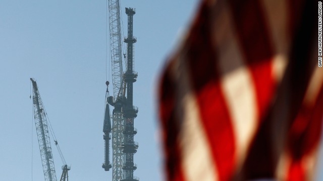 Ironworkers wait for the final piece of the One World Trade Center spire to be raised into position for attachment to the building in New York on Friday, May 10. The 408-foot spire brings the building to a height of 1,776 feet, making it the tallest in the Western Hemisphere.