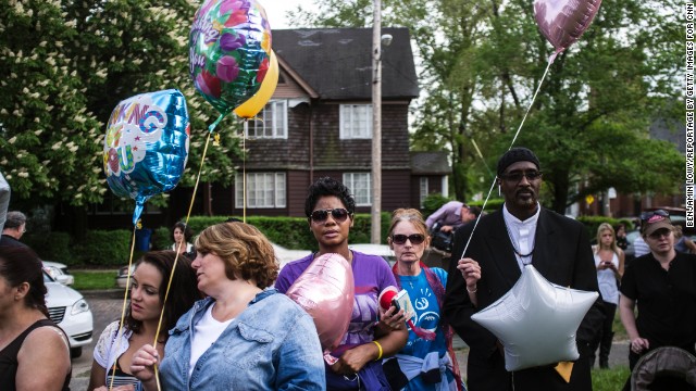 People hold balloons during a community balloon-release service in kidnapping victim Michelle Knight's honor. 