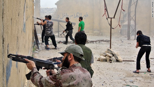Rebel fighters fire at government forces in the northern Syrian city of Aleppo on Sunday, May 12. 