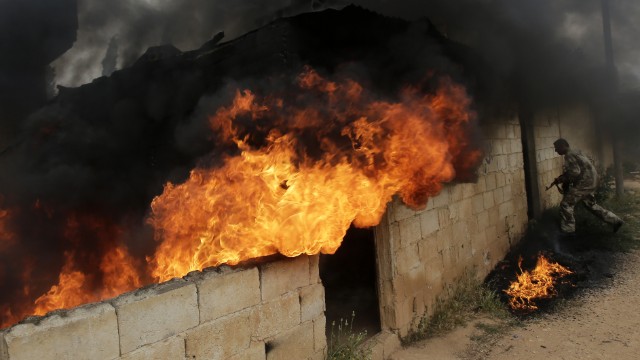 Syrian army soldiers take control of the village of Western Dumayna north of the rebel-held city of Qusayr on Monday, May 13. Syrian troops captured three villages in Homs province, allowing them to cut supply lines to rebels inside Qusayr town, a military officer told AFP. 