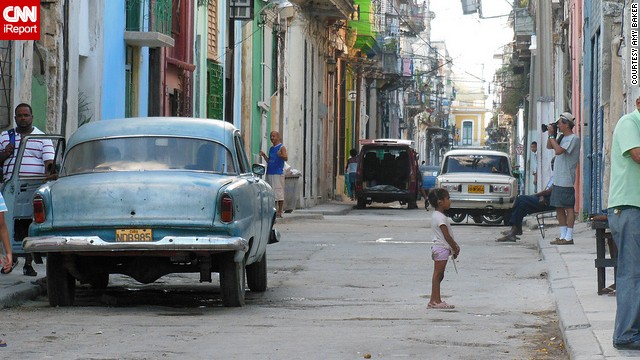 A little girl <a href='http://ireport.cnn.com/docs/DOC-911375'>waits for her playmate</a> in the vibrant streets of Havana, Cuba.