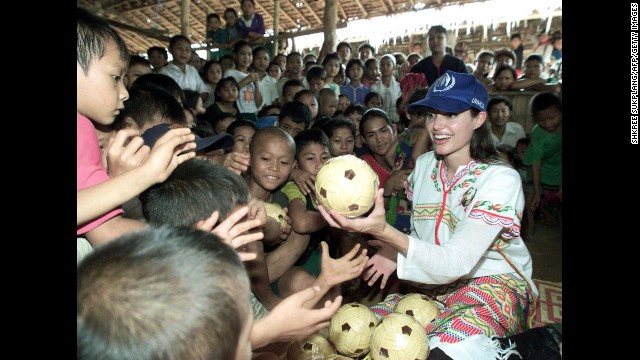 Jolie distributes balls to the children at the Tham Hin refugee camp on the Thai-Myanmar border in May 2002. She is a goodwill ambassador for the United Nations high commissioner for refugees.