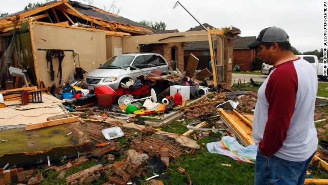 Pete Alaniz eyes damage to the garage of his Cleburne, Texas, rental home on May 16.