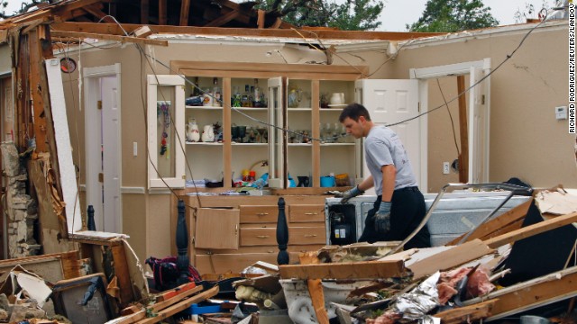 A rescue worker sifts through rubble on May 16 in Granbury, southwest of Fort Worth. 