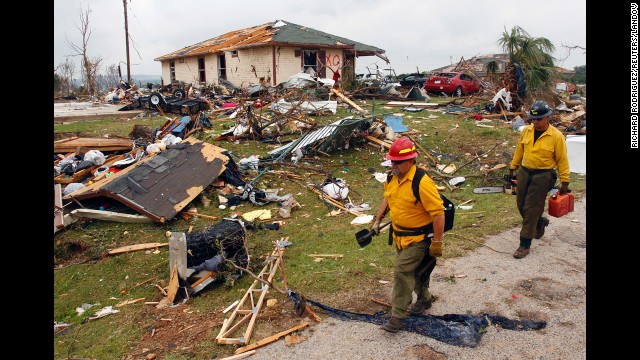 Rescue personnel pass remnants of destroyed houses in Granbury on May 16. There were reports of homes in Granbury being flattened with people inside.