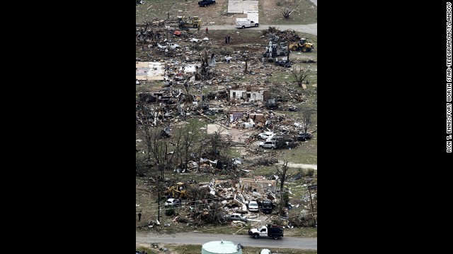 Debris from damaged homes litters a neighborhood in Granbury on Thursday, May 16.