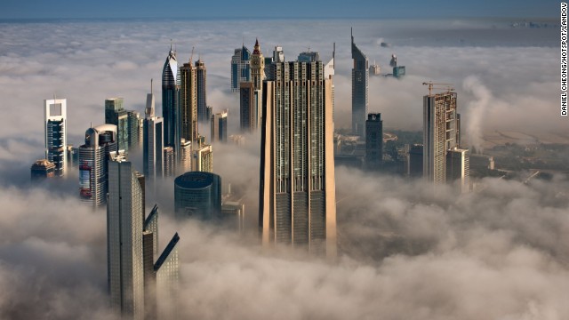 Looking north from the 101st floor of the Burj Khalifa, the Index Tower, center, and other skyscrapers stand high above the clouds.