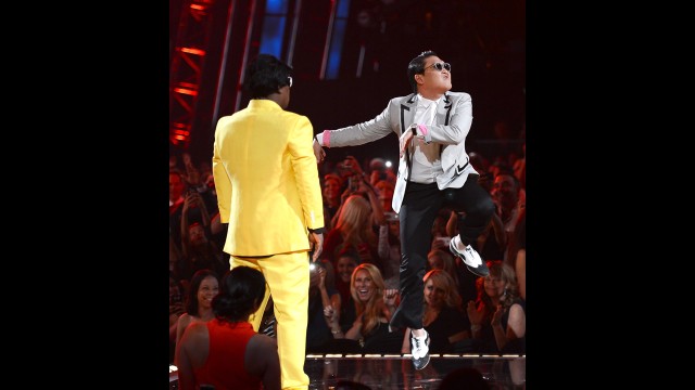 Host Tracy Morgan and musician Psy speak onstage.