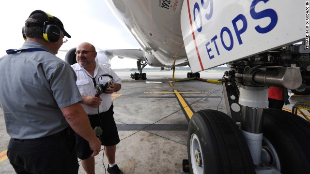 United Airlines maintenance workers prepare the plane for flight. 