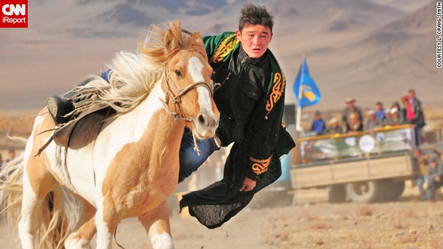 In a traditional sport, Mongolian riders try to find and pick up a coin from the ground without falling off their galloping horse. See more photos and learn about the event on <a href='http://ireport.cnn.com/docs/DOC-858754'>CNN iReport</a>.