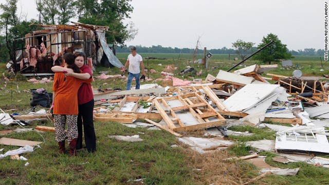 Shawnee, Oklahoma, residents embrace on May 20 as they search through the remains of their home, destroyed by a tornado on May 19. 