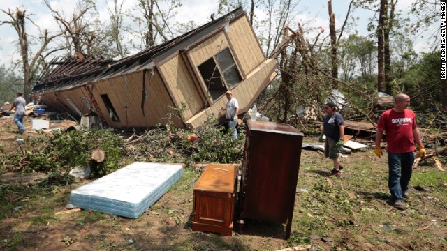 Volunteers help clean out Jean McAdams' mobile home on Monday, May 20, after it was overturned by a tornado on Sunday near Shawnee, Oklahoma. Dozens of tornadoes were reported in Oklahoma, Kansas, Illinois and Iowa on Sunday and Monday, according to the National Weather Service, with Oklahoma and Kansas the hardest-hit.