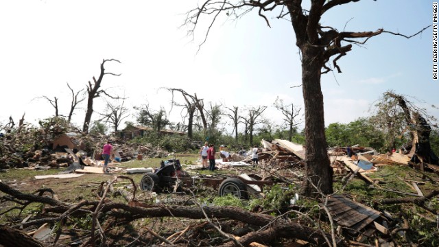 Tom and Ronda Clark get help with cleanup on May 20, after their property near Shawnee, Oklahoma, was damaged by a tornado the day before.
