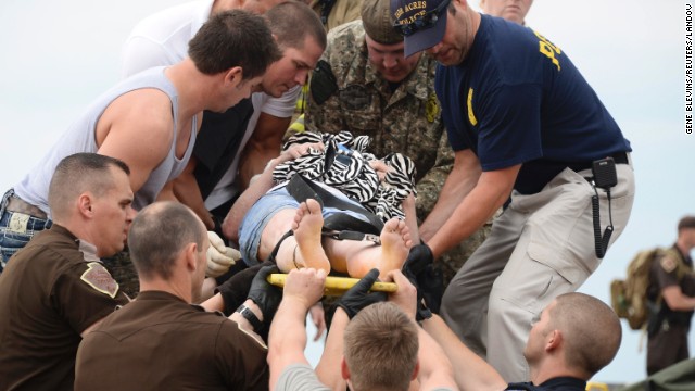 A woman is transported on a stretcher after she was rescued from the damaged medical center in Moore on May 20.