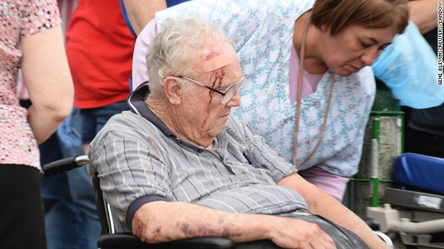 A nurse helps an older man who suffered a head injury on May 20 in Moore.