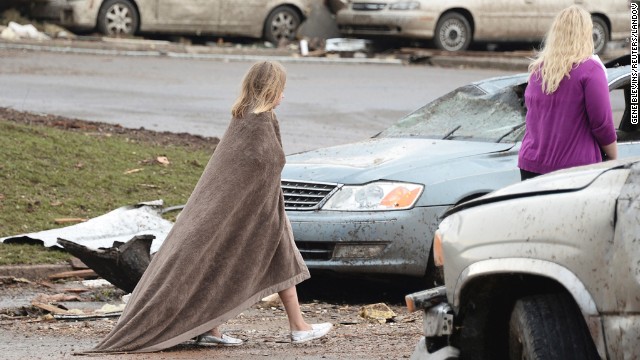 A girl wraps herself in a blanket near the Moore Hospital on May 20.