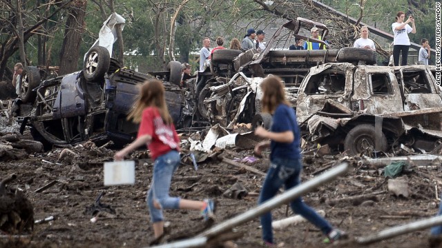 People look through the wreckage of their neighborhood after a tornado struck Moore, Oklahoma, on May 20.