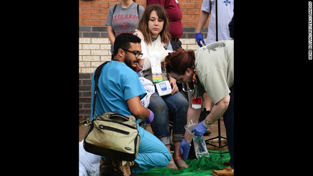 A woman is treated for her injuries on May 20 at a triage area set up for the wounded.