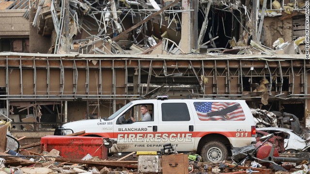 A fire official drives through the rubble of Moore Medical Center on May 20.