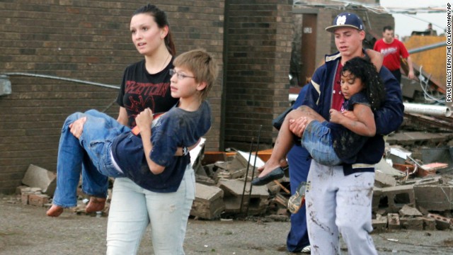 Teachers carry children away from Briarwood Elementary School on May 20.