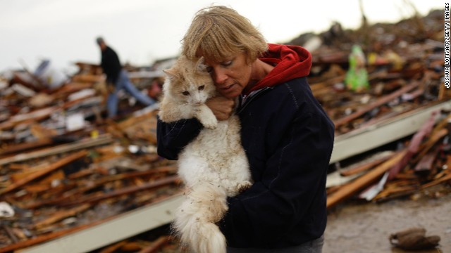 June Simson embraces her cat Sammi after she found him standing among the rubble of her destroyed home in Moore on May 21.