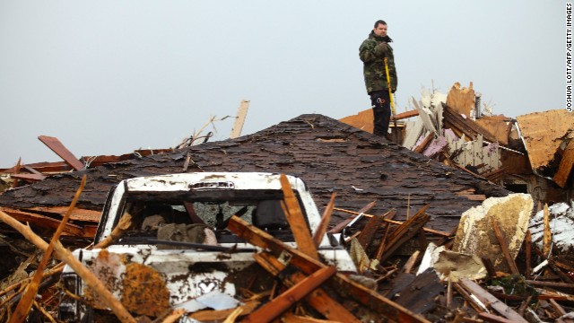 A man stands on the roof of a destroyed home in Moore on May 21.