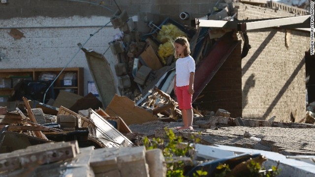 A young girl stands among the rubble outside of Briarwood Elementary School on Tuesday, May 21, after an extremely powerful tornado tore through Moore, Oklahoma, on Monday, May 20. The storm was part of a tornado outbreak that began in the Midwest and Plains on Sunday, May 19. <a href='http://www.cnn.com/2013/05/20/us/gallery/midwest-weather/index.html'>View more photos of the aftermath in the region</a> and another gallery of <a href='http://www.cnn.com/2013/05/21/us/gallery/oklahoma-tornado-aerials/index.html'>aerial shots of the damage</a>.