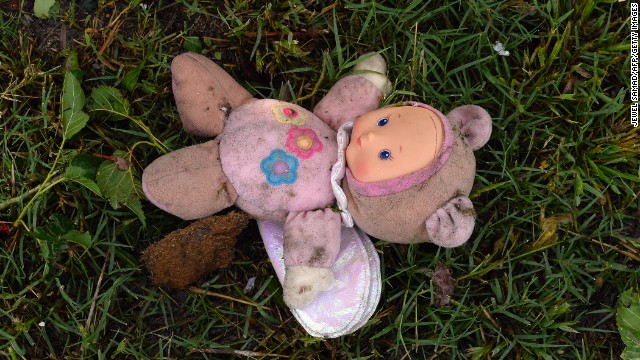 A doll covered in dirt is among the rubble scattered throughout a neighborhood in Moore on May 21.