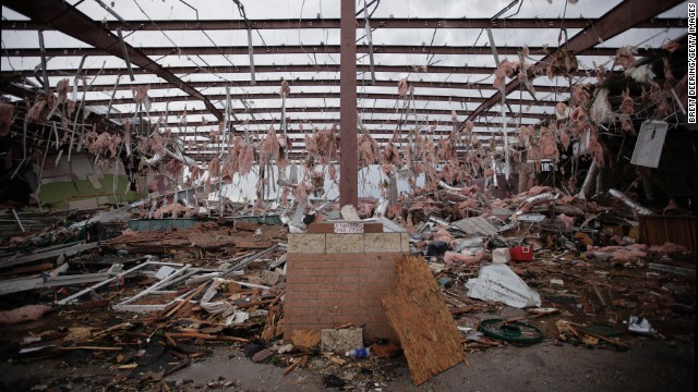 Tufts of pink insulation hang from the rafters of a store in Moore on May 21 that was destroyed in the storm.