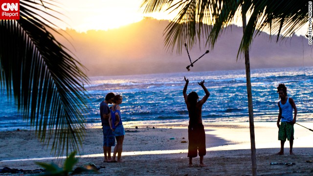 Jugglers practice on the beach. "I thought the <a href='http://ireport.cnn.com/docs/DOC-809299'>colors at this time of day</a> were magical," said Jon Nichols.