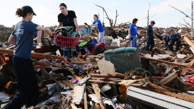 Volunteers form a chain to retrieve clothing and other household items on May 22.