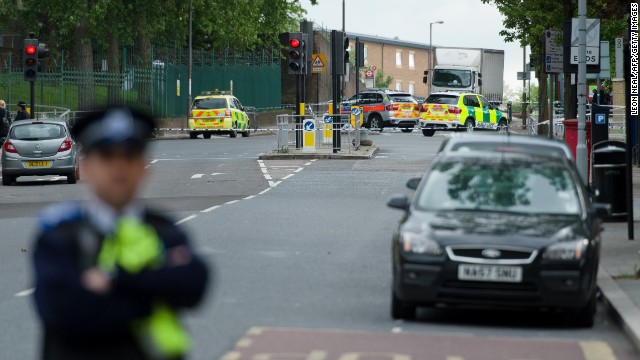 A police officer guards a blocked off area in Woolwich, East London, on May 22, following an incident in which a man was killed and two others seriously injured.