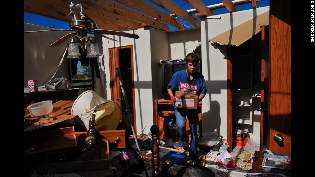 Jake English, 12, cleans up retired school counselor Kay Taylor's home on May 22 in south Oklahoma City, just west of Moore. The storm was part of a tornado outbreak that began in the Midwest and Plains on Sunday, May 19. 