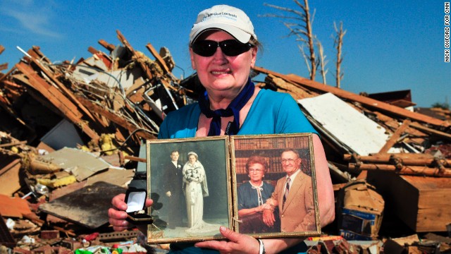 Carolyn Booher found her husband's wedding ring and several photos of her parents in the debris.