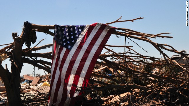 A flag hangs from a tree in a neighborhood in Moore that was in the direct path of the Oklahoma tornado.