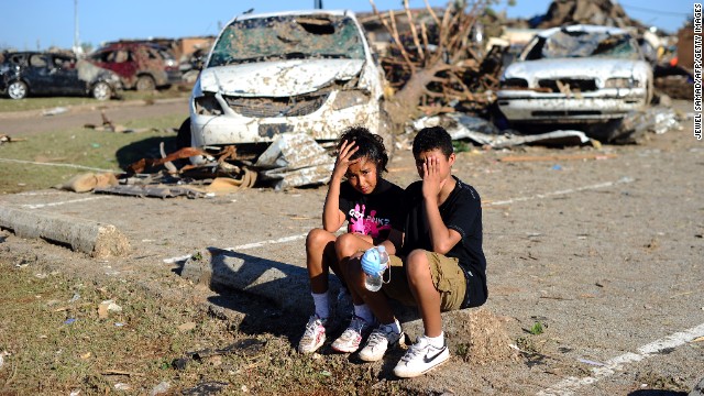 Plaza Towers Elementary School students Monica Boyd and Lavontey Rodriguez sit at the parking lot of their tornado devastated school.