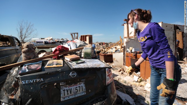 Tara McDonald shows some items salvaged from her home on May 22.