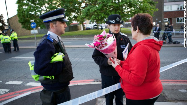 Mary Warder brings flowers to the scene of the crime on May 22 to pay respects to the victim.