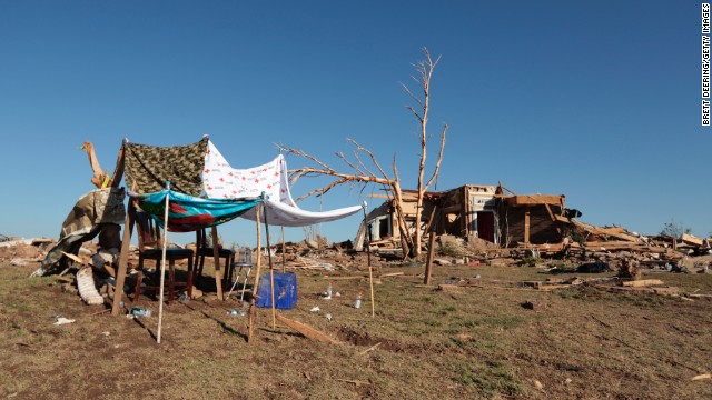 A makeshift shelter stands next to a home destroyed by the tornado on May 22.