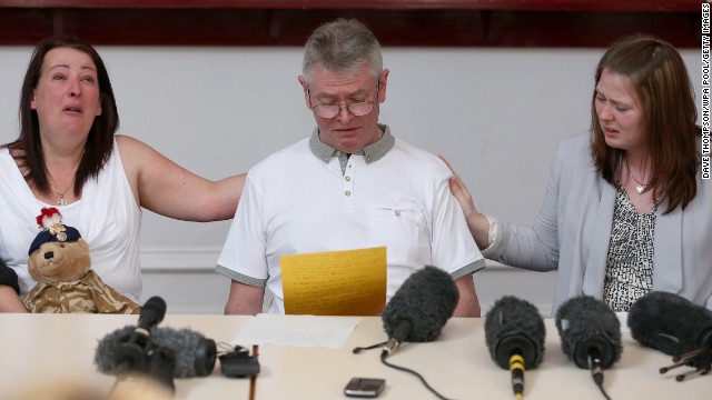 Left to right: mother of the slain soldier Lyn Rigby, stepfather Ian Rigby and Lee's wife Rebecca Rigby grieve as Ian reads a family statement on Friday, May 24 in Bury, England.