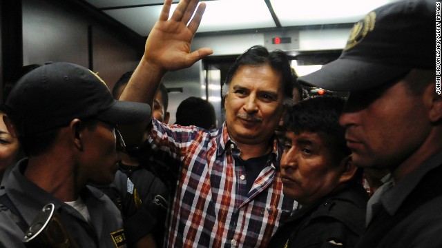 Former Guatemalan President Alfonso Portillo waves upon arrival in court in Guatemala City on January 31.