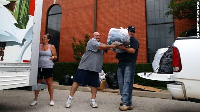 Volunteers unload donated items for tornado victims at the Yellow Rose Theater on May 25 in Moore.